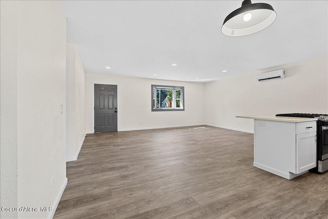 1038 N 15th St, Coeur Dalene, ID 83814 - unfurnished living room featuring a wall mounted AC, wood finished floors, and recessed lighting