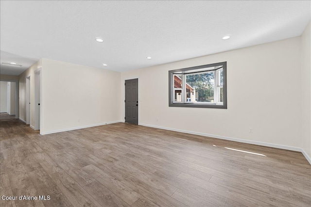 1038 N 15th St, Coeur Dalene, ID 83814 - empty room featuring wood finished floors, recessed lighting, and a textured ceiling