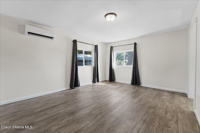 1038 N 15th St, Coeur Dalene, ID 83814 - empty room with an AC wall unit and wood finished floors