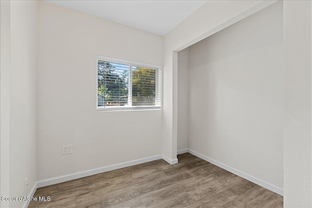 1038 N 15th St, Coeur Dalene, ID 83814 - empty room with wood finished floors and baseboards