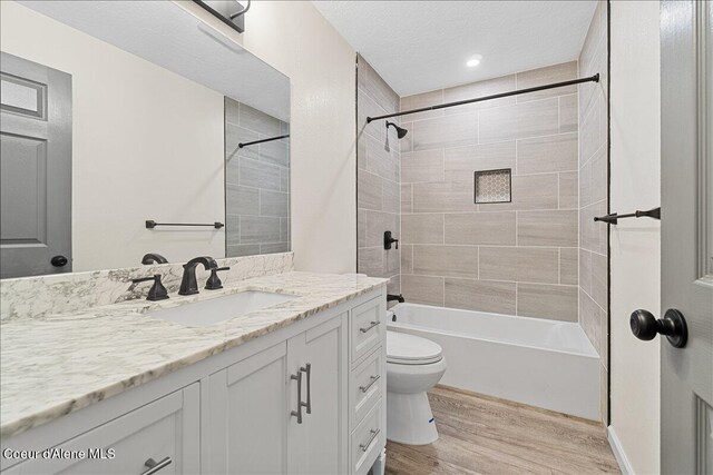 1038 N 15th St, Coeur Dalene, ID 83814 - full bathroom with vanity, wood finished floors, tub / shower combination, and a textured ceiling