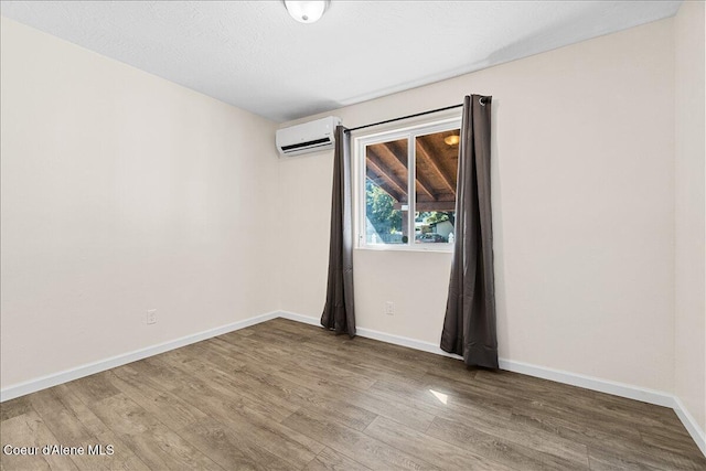1038 N 15th St, Coeur Dalene, ID 83814 - spare room with a wall mounted air conditioner and wood finished floors