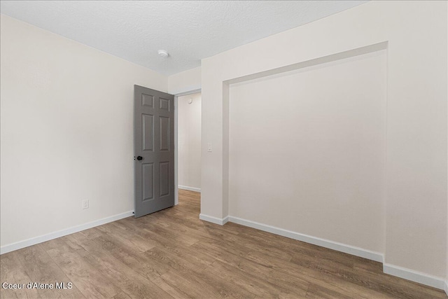 1038 N 15th St, Coeur Dalene, ID 83814 - unfurnished bedroom featuring wood finished floors and baseboards