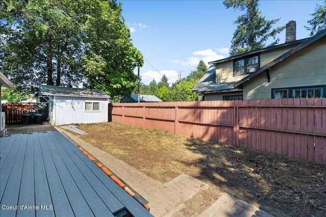 1038 N 15th St, Coeur Dalene, ID 83814 - wooden deck with a fenced backyard and a storage unit