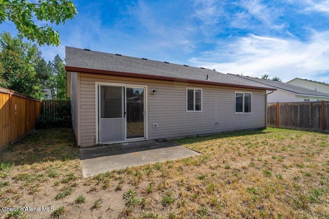 2533 W Grenoble Ln, Coeur Dalene, ID 83815 - back of house featuring a fenced backyard and a patio area