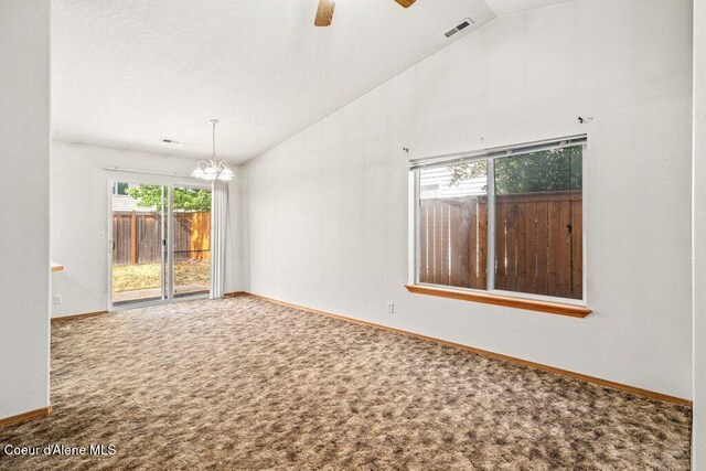 2533 W Grenoble Ln, Coeur Dalene, ID 83815 - carpeted spare room featuring lofted ceiling, plenty of natural light, a chandelier, and ceiling fan