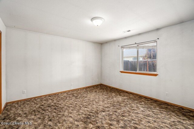 2533 W Grenoble Ln, Coeur Dalene, ID 83815 - carpeted empty room with baseboards