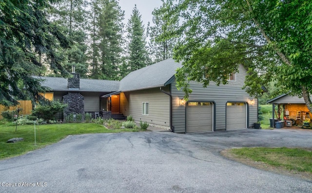 6531 Tannenbaum Cir, Bonners Ferry, ID 83805 - view of front of home with driveway, a front yard, and a chimney