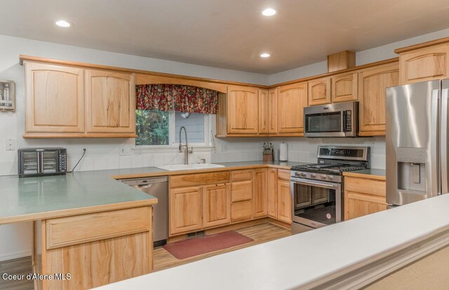 6531 Tannenbaum Cir, Bonners Ferry, ID 83805 - kitchen featuring appliances with stainless steel finishes, light brown cabinets, recessed lighting, and a peninsula