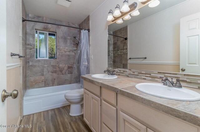 6531 Tannenbaum Cir, Bonners Ferry, ID 83805 - bathroom with shower / bath combo, double vanity, and wood finished floors