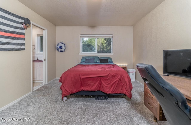 6531 Tannenbaum Cir, Bonners Ferry, ID 83805 - bedroom with carpet, an office area, ensuite bathroom, and a textured ceiling