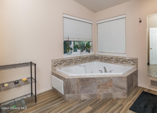 6531 Tannenbaum Cir, Bonners Ferry, ID 83805 - bathroom with wood finished floors, a tub with jets, and vaulted ceiling