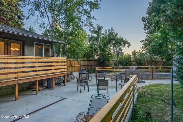 6531 Tannenbaum Cir, Bonners Ferry, ID 83805 - fenced backyard featuring a deck and a patio area