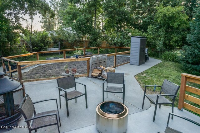 6531 Tannenbaum Cir, Bonners Ferry, ID 83805 - fenced backyard featuring a patio area and an outdoor fire pit