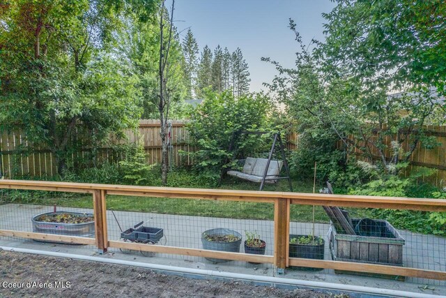 6531 Tannenbaum Cir, Bonners Ferry, ID 83805 - fenced backyard with a vegetable garden