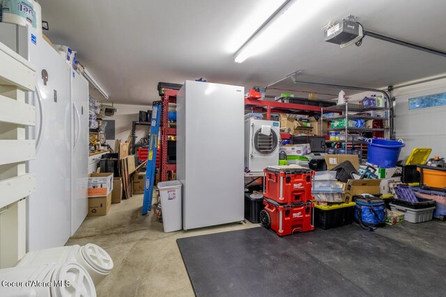 6531 Tannenbaum Cir, Bonners Ferry, ID 83805 - garage with a garage door opener and stacked washing machine and dryer