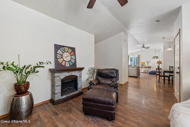8562 N Audubon Dr, Hayden, ID 83835 - living area featuring a ceiling fan, vaulted ceiling, wood finished floors, and a fireplace