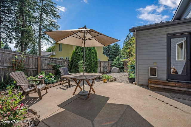 8562 N Audubon Dr, Hayden, ID 83835 - fenced backyard with outdoor dining area, a patio, and entry steps