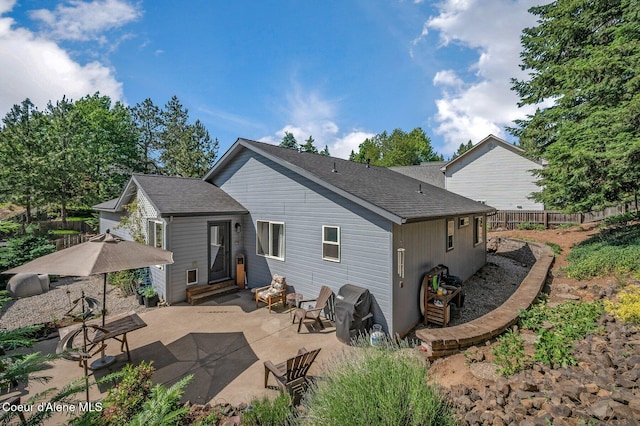 8562 N Audubon Dr, Hayden, ID 83835 - back of property featuring a patio, entry steps, and a shingled roof