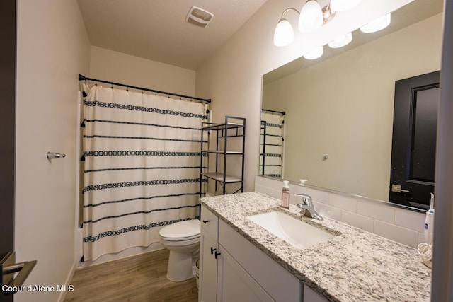 5987 W Quinn Way, Rathdrum, ID 83858 - full bath featuring wood finished floors, tasteful backsplash, and vanity