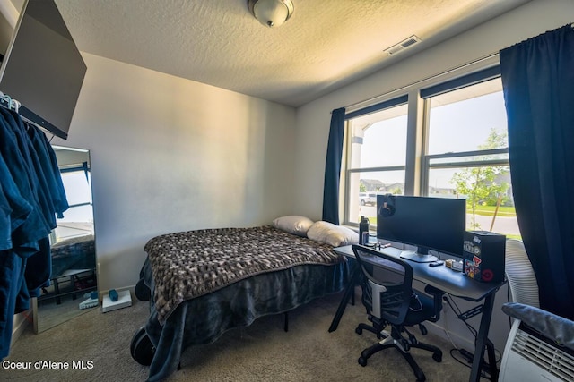 5987 W Quinn Way, Rathdrum, ID 83858 - bedroom featuring carpet flooring, a textured ceiling, and an office area