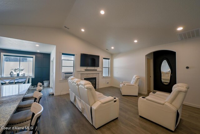 5987 W Quinn Way, Rathdrum, ID 83858 - living room featuring dark wood-style floors, lofted ceiling, healthy amount of natural light, a brick fireplace, and cooling unit