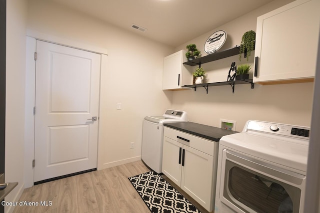 5987 W Quinn Way, Rathdrum, ID 83858 - washroom featuring cabinet space, washing machine and dryer, and light wood-style floors