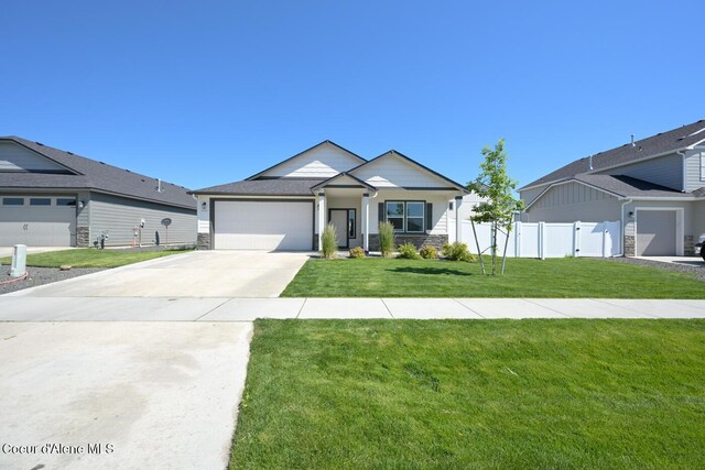 5987 W Quinn Way, Rathdrum, ID 83858 - ranch-style house featuring a garage, concrete driveway, and stone siding