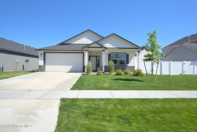 5987 W Quinn Way, Rathdrum, ID 83858 - view of front of house with an attached garage, stone siding, and concrete driveway
