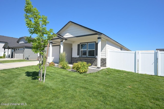5987 W Quinn Way, Rathdrum, ID 83858 - view of front of home featuring an attached garage, stone siding, and concrete driveway