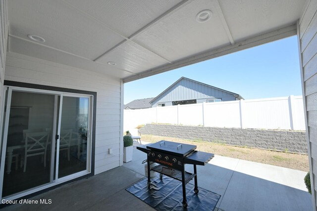 5987 W Quinn Way, Rathdrum, ID 83858 - fenced backyard featuring a patio and grilling area