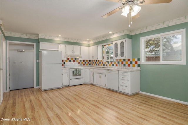 1502 N Melrose St, Coeur Dalene, ID 83814 - kitchen featuring white appliances, light countertops, under cabinet range hood, and light wood finished floors