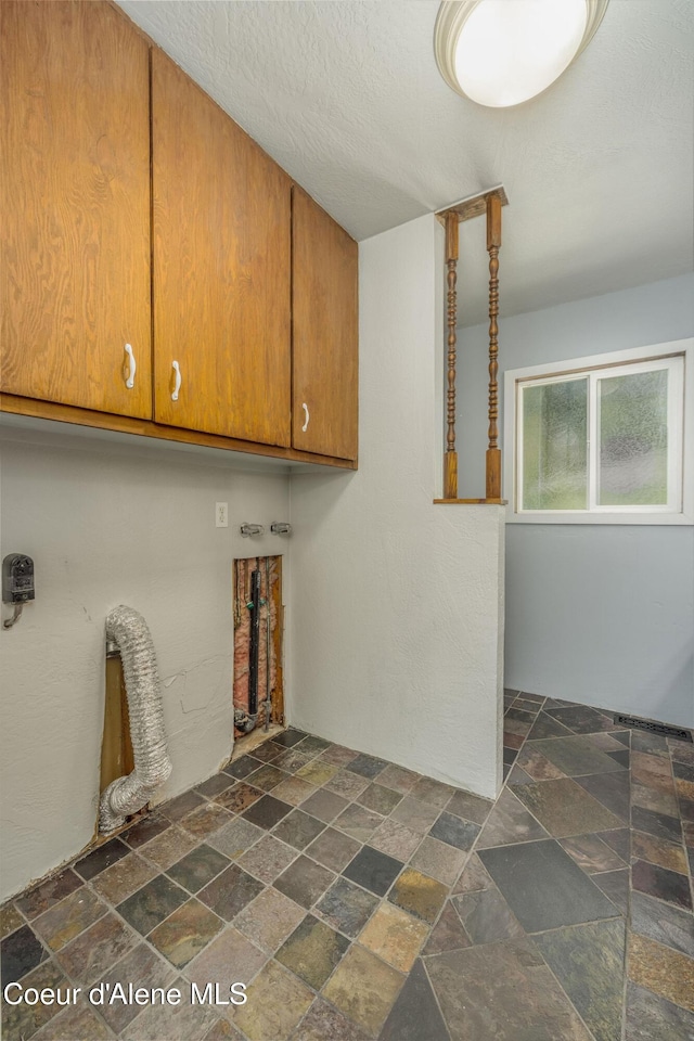 1502 N Melrose St, Coeur Dalene, ID 83814 - laundry room with stone tile floors and cabinet space