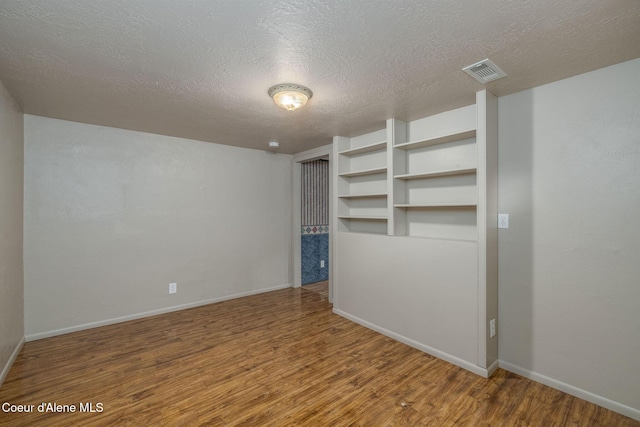 1502 N Melrose St, Coeur Dalene, ID 83814 - unfurnished bedroom featuring wood finished floors and a textured ceiling