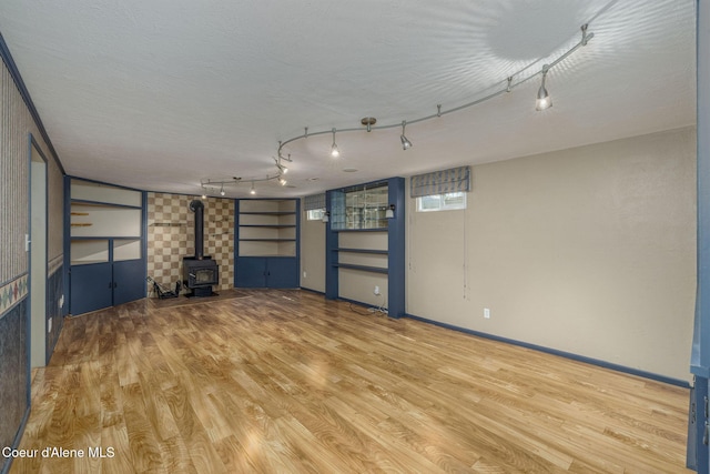 1502 N Melrose St, Coeur Dalene, ID 83814 - unfurnished living room with a wood stove and wood finished floors