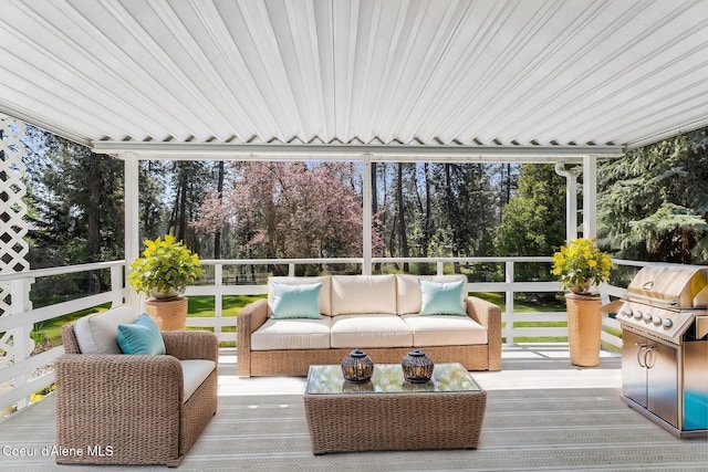 4206 W Appaloosa Rd, Coeur Dalene, ID 83815 - wooden deck featuring grilling area, view of scattered trees, and an outdoor hangout area