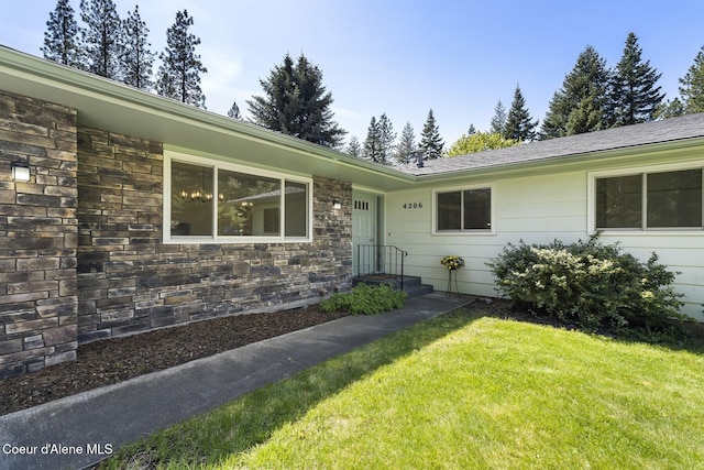 4206 W Appaloosa Rd, Coeur Dalene, ID 83815 - view of exterior entry with a lawn and stone siding