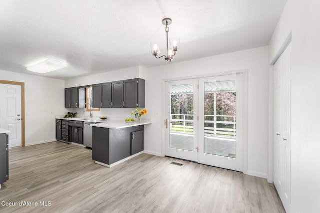 4206 W Appaloosa Rd, Coeur Dalene, ID 83815 - kitchen featuring light countertops, light wood finished floors, a chandelier, a peninsula, and decorative light fixtures