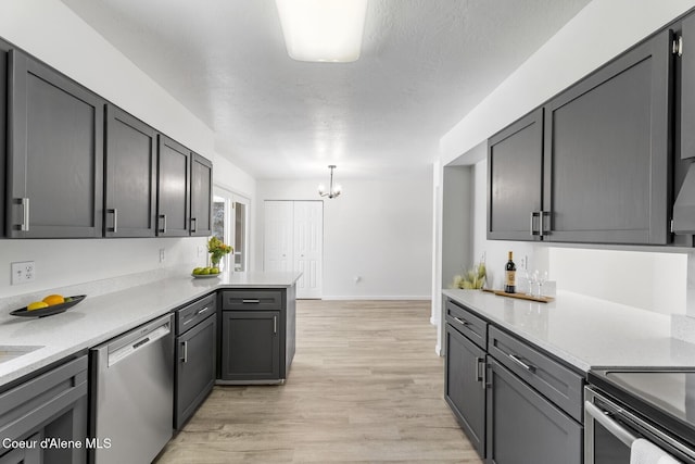 4206 W Appaloosa Rd, Coeur Dalene, ID 83815 - kitchen with dishwasher, light countertops, light wood-style flooring, a chandelier, and a peninsula