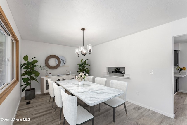 4206 W Appaloosa Rd, Coeur Dalene, ID 83815 - dining area featuring light wood-style floors and a chandelier