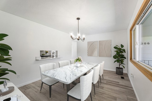 4206 W Appaloosa Rd, Coeur Dalene, ID 83815 - dining room with a chandelier and wood finished floors