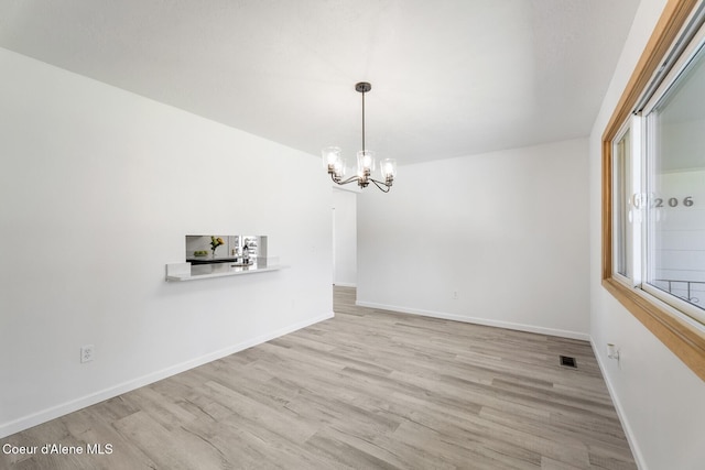 4206 W Appaloosa Rd, Coeur Dalene, ID 83815 - unfurnished dining area featuring a chandelier and wood finished floors