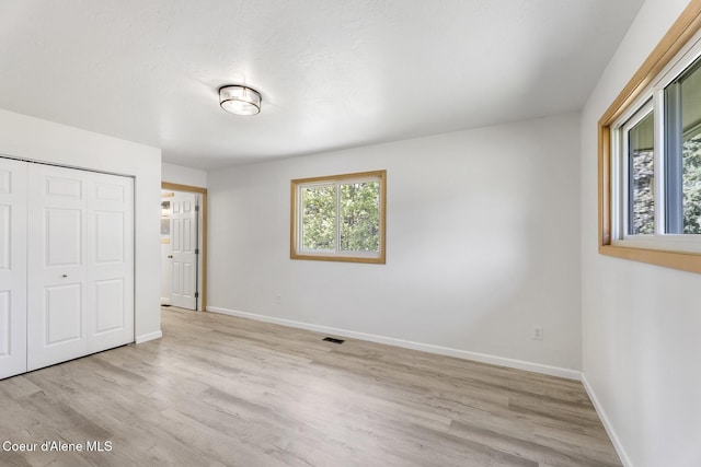 4206 W Appaloosa Rd, Coeur Dalene, ID 83815 - unfurnished bedroom with light wood-style floors and a closet