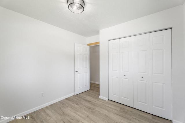 4206 W Appaloosa Rd, Coeur Dalene, ID 83815 - unfurnished bedroom featuring light wood finished floors and a closet