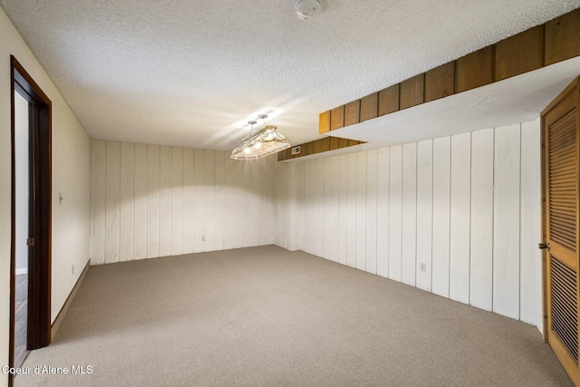 4206 W Appaloosa Rd, Coeur Dalene, ID 83815 - basement with carpet, wooden walls, and a textured ceiling