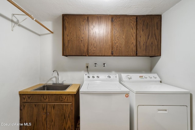 4206 W Appaloosa Rd, Coeur Dalene, ID 83815 - washroom featuring cabinet space, washing machine and dryer, and a textured ceiling