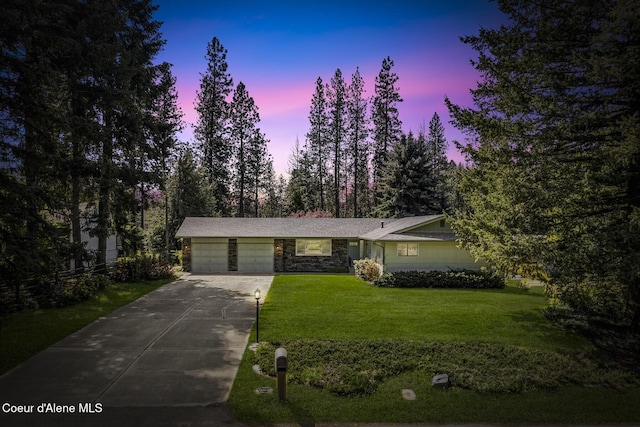 4206 W Appaloosa Rd, Coeur Dalene, ID 83815 - view of front of home featuring a garage, driveway, a front lawn, and stone siding