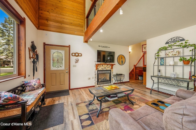 306 Scranton Ave, Coolin, ID 83821 - living room featuring stairs, a tile fireplace, and wood finished floors