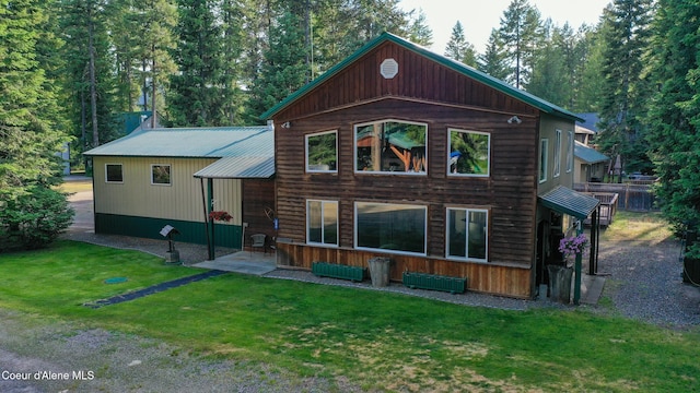 306 Scranton Ave, Coolin, ID 83821 - rear view of property with a lawn, a patio, and a metal roof