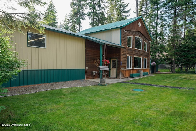 306 Scranton Ave, Coolin, ID 83821 - rustic home with a front lawn and a patio